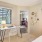 a bedroom with a bed desk and a window