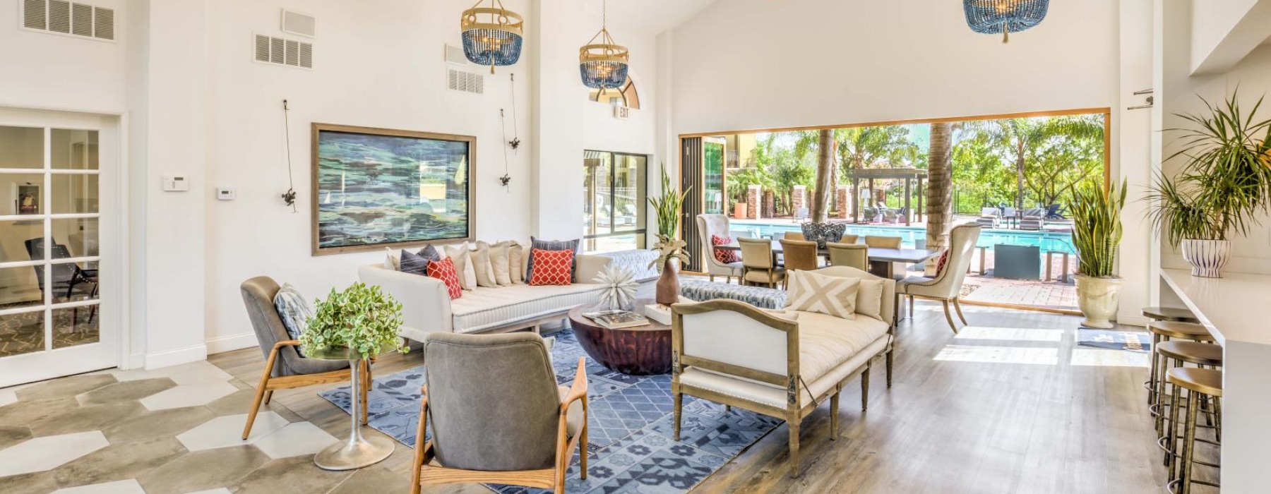 resident lounge with chairs and couches and large windows