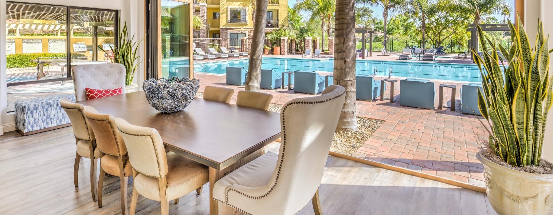 Dining area in community center with view of the pool at Overlook at Bernardo Heights apartments in San Diego County