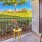 a patio with a table and chairs and a tree and a fence