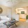 a living room with a white couch and a ceiling fan