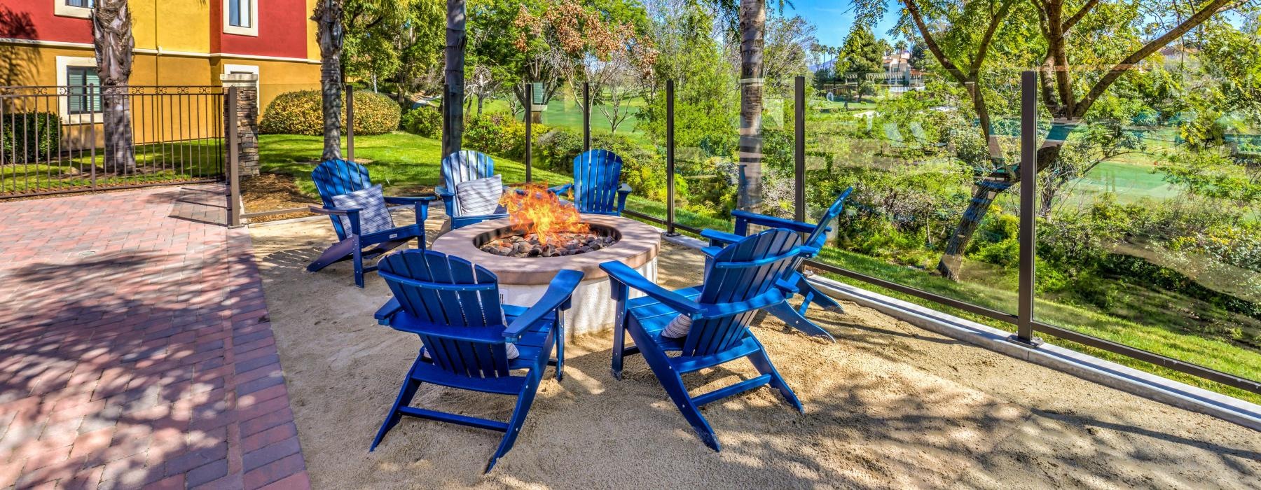 Outdoor fire pit surrounded by chairs at Overlook at Bernardo Heights apartments in San Diego