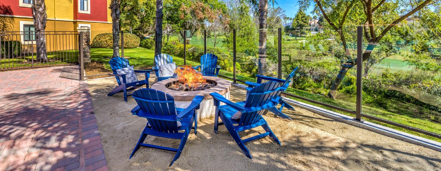 Outdoor fire pit surrounded by chairs at Overlook at Bernardo Heights pet-friendly apartments in San Diego